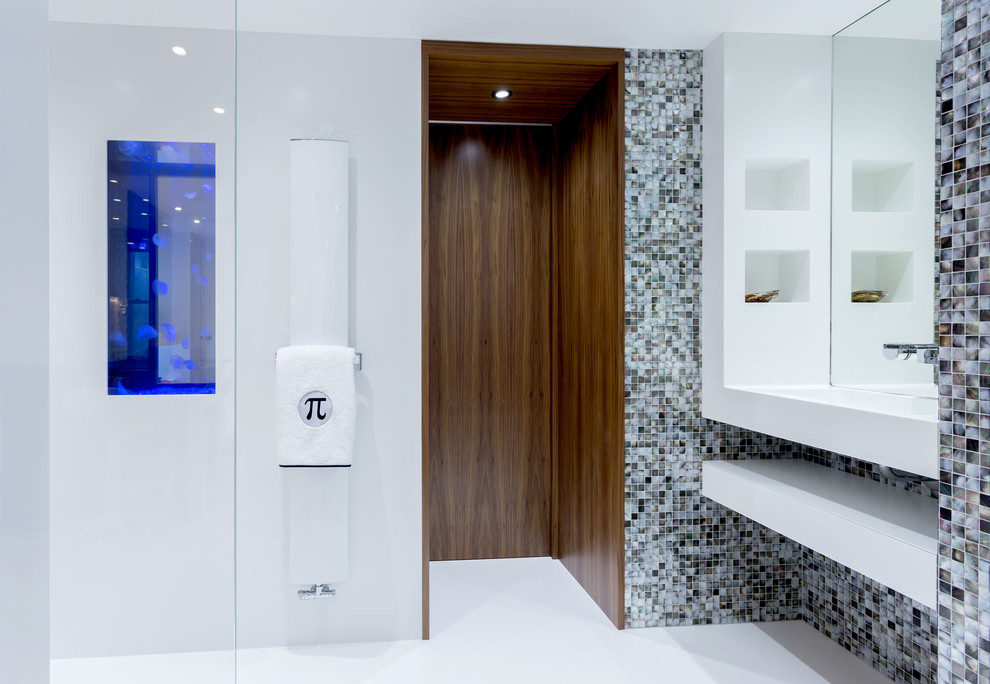 Idée de décoration pour une salle d'eau design avec une douche ouverte, WC suspendus, un carrelage multicolore, mosaïque et un mur blanc.