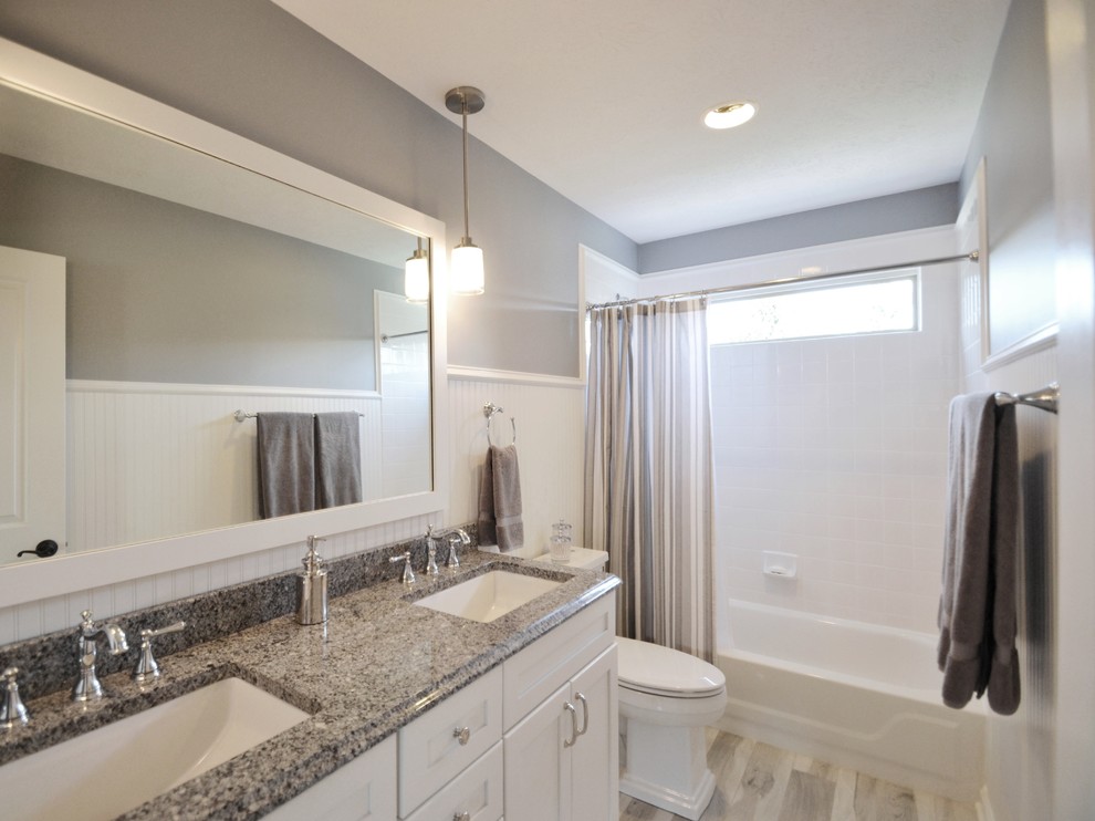 Inspiration for a small modern family bathroom in Indianapolis with recessed-panel cabinets, white cabinets, grey tiles, grey walls and vinyl flooring.