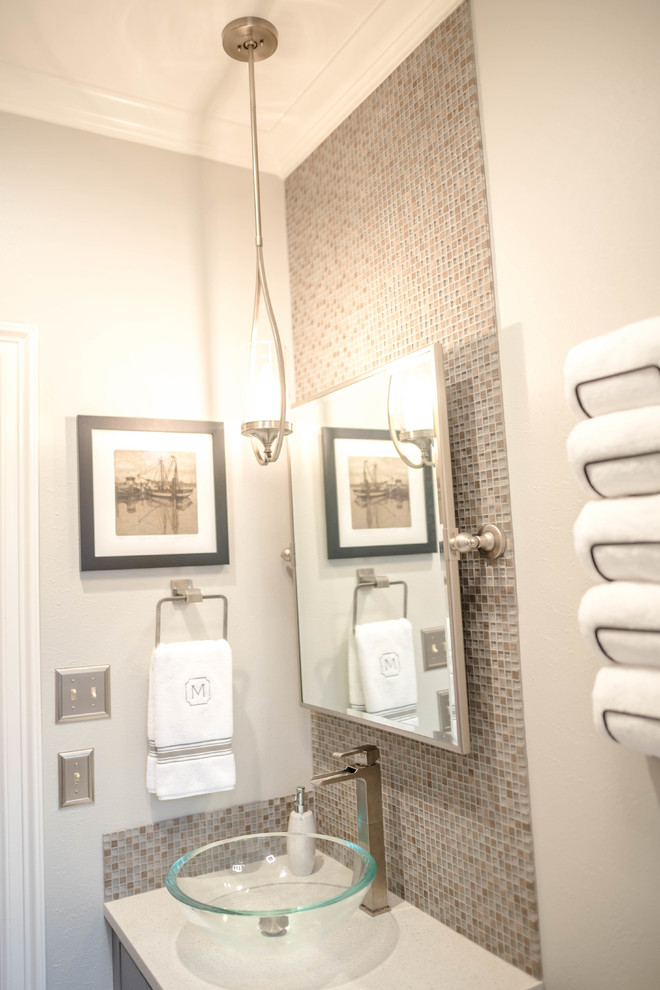 Small modern ensuite bathroom in New Orleans with freestanding cabinets, grey cabinets, an alcove bath, a shower/bath combination, a one-piece toilet, grey tiles, ceramic tiles, grey walls, ceramic flooring, a vessel sink, engineered stone worktops, grey floors, an open shower and white worktops.