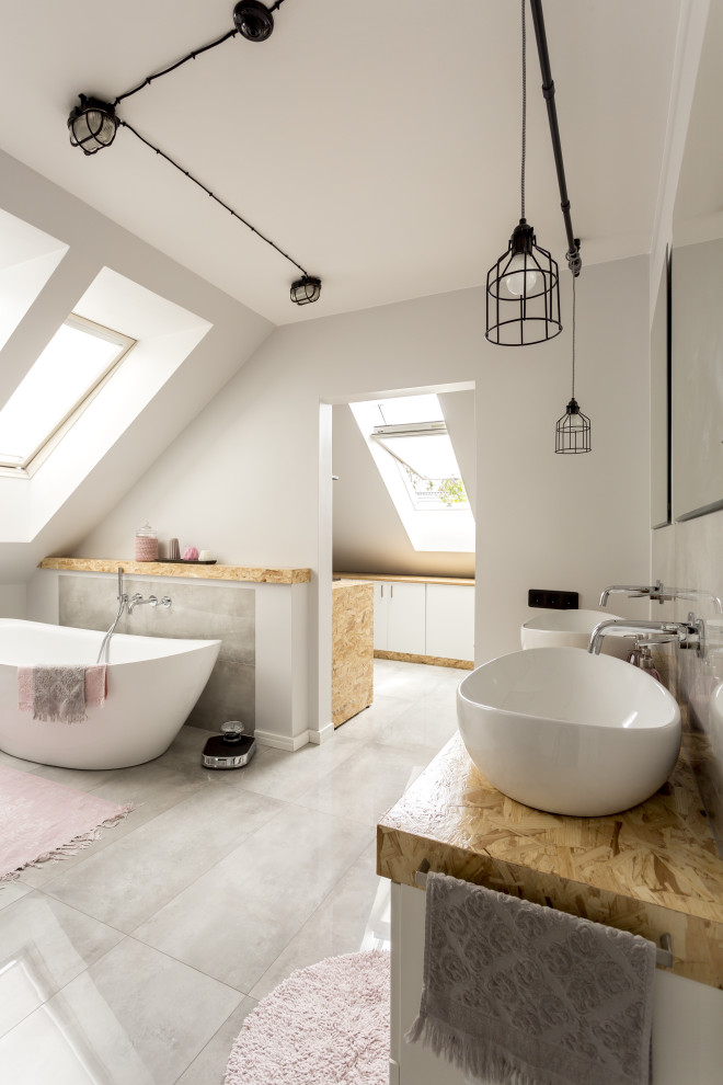 Large trendy master gray tile and porcelain tile porcelain tile, gray floor, double-sink and vaulted ceiling bathroom photo in San Francisco with flat-panel cabinets, white cabinets, a wall-mount toilet, white walls, a hinged shower door, beige countertops and a floating vanity