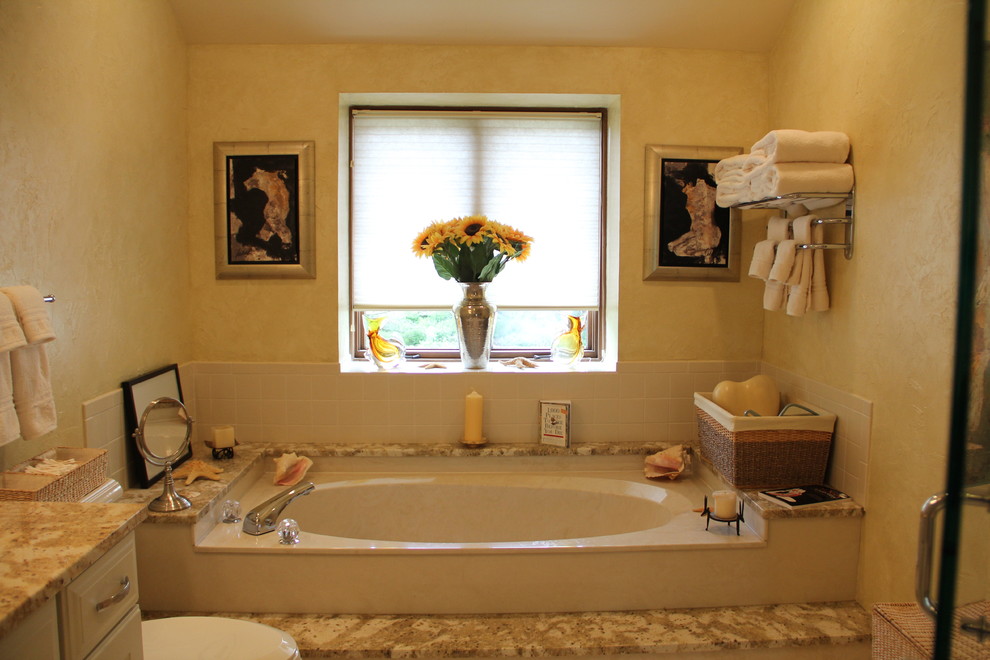 На фото: главная ванная комната среднего размера в классическом стиле с врезной раковиной, накладной ванной и полом из керамической плитки