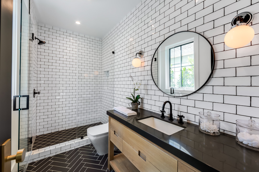 This is an example of a classic shower room bathroom in Los Angeles with flat-panel cabinets, light wood cabinets, an alcove shower, white tiles, metro tiles, a submerged sink, black floors, a hinged door and black worktops.