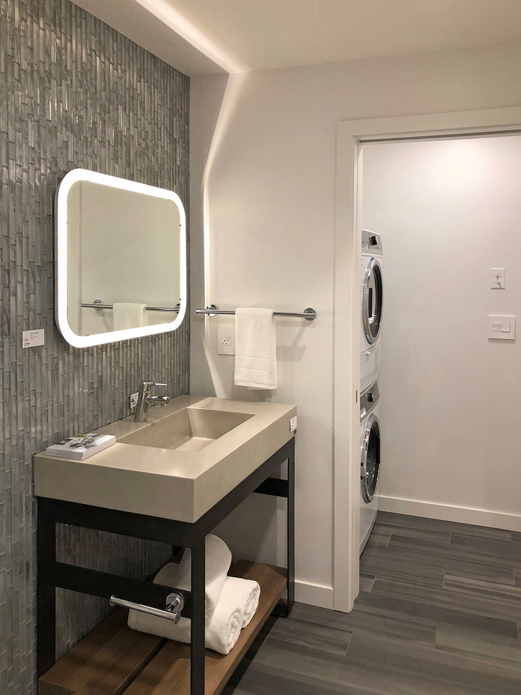 This is an example of a small contemporary family bathroom in Los Angeles with freestanding cabinets, dark wood cabinets, a built-in bath, a walk-in shower, a one-piece toilet, white tiles, porcelain tiles, white walls, porcelain flooring, an integrated sink, concrete worktops, grey floors and a hinged door.
