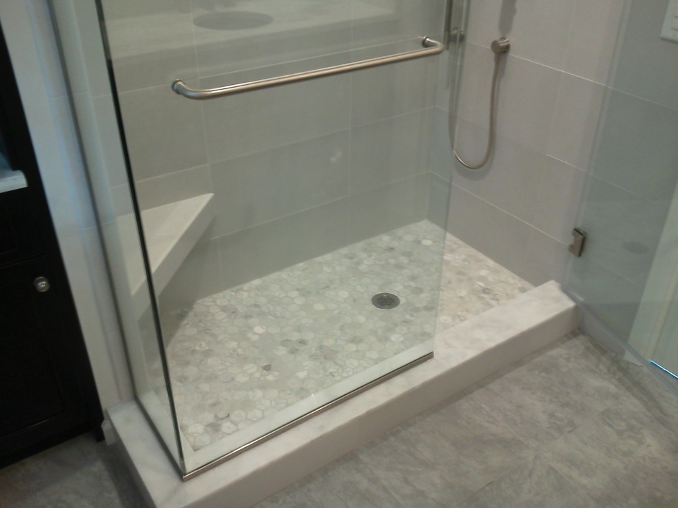 Example of a mid-sized classic gray tile and porcelain tile marble floor alcove shower design in Tampa with a vessel sink, furniture-like cabinets, black cabinets, marble countertops, a one-piece toilet and gray walls