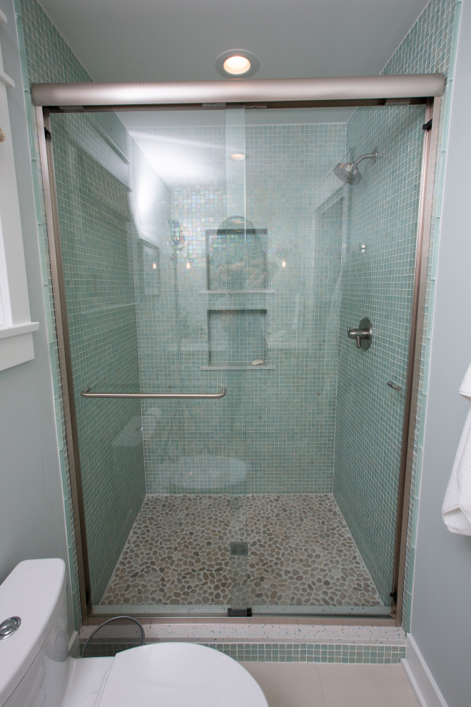 Small shower room bathroom in Other with shaker cabinets, white cabinets, an alcove shower, a one-piece toilet, green tiles, glass tiles, blue walls, porcelain flooring, a submerged sink, engineered stone worktops, beige floors, a hinged door, green worktops, a wall niche, a single sink and a built in vanity unit.