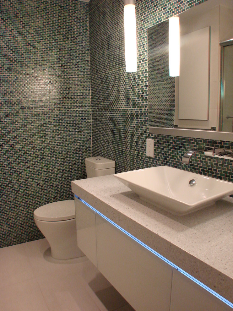 Bathroom - mid-sized modern blue tile, green tile and mosaic tile porcelain tile and beige floor bathroom idea in DC Metro with flat-panel cabinets, white cabinets, a one-piece toilet, multicolored walls and a vessel sink