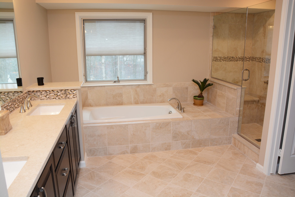 Large elegant master beige tile and ceramic tile ceramic tile corner shower photo in DC Metro with raised-panel cabinets, dark wood cabinets, a hot tub, a two-piece toilet, beige walls, an undermount sink and quartz countertops