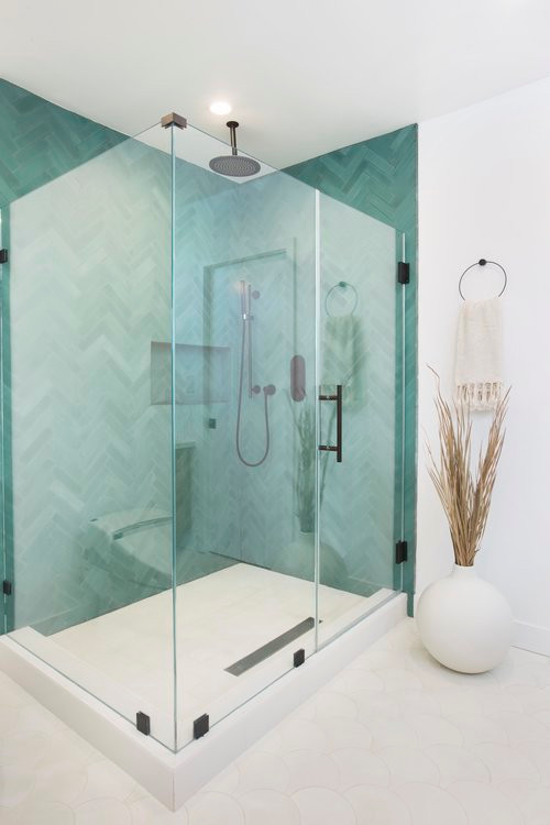 Example of a mid-sized danish master blue tile and ceramic tile ceramic tile and white floor corner shower design in Los Angeles with white walls and a hinged shower door