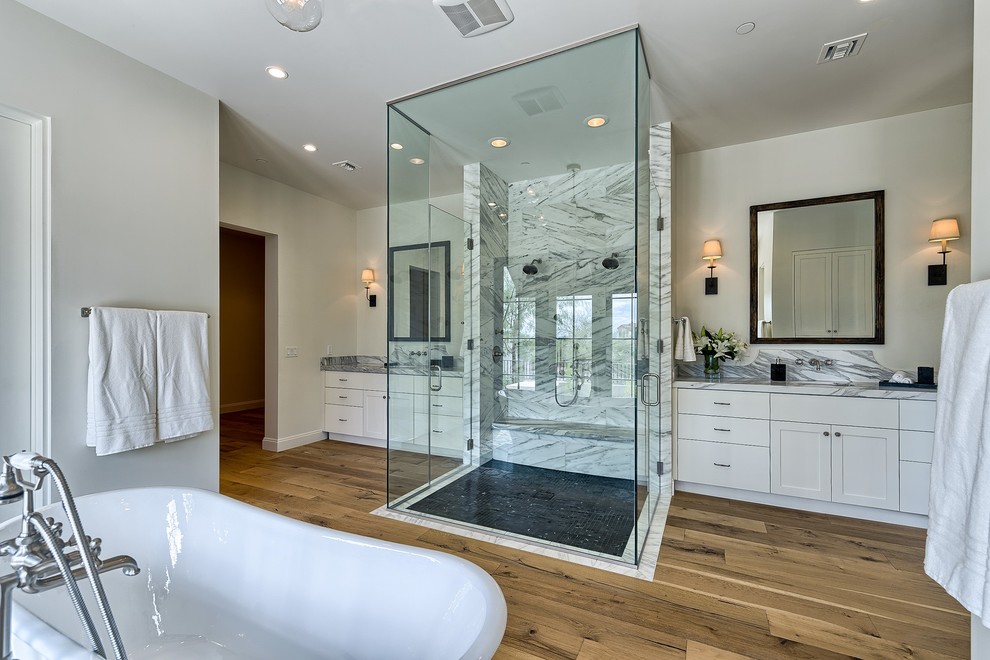 Large tuscan master medium tone wood floor and brown floor bathroom photo in Phoenix with shaker cabinets, white cabinets, gray walls, an undermount sink, quartz countertops and a hinged shower door