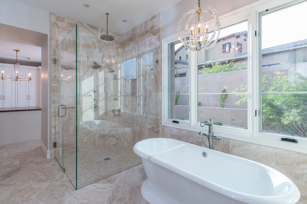 Design ideas for an expansive traditional ensuite bathroom in Phoenix with raised-panel cabinets, beige cabinets, a freestanding bath, a corner shower, a one-piece toilet, beige tiles, marble tiles, grey walls, a submerged sink, marble worktops and a hinged door.