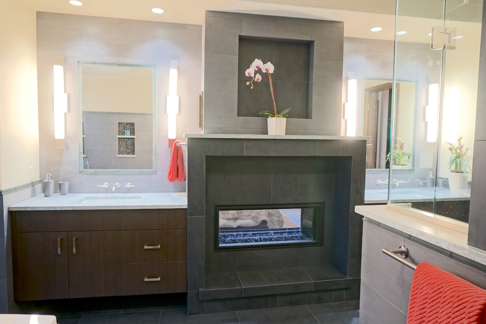 This is an example of a medium sized modern ensuite bathroom in Denver with flat-panel cabinets, dark wood cabinets, a japanese bath, a corner shower, a one-piece toilet, green tiles, porcelain tiles, beige walls, porcelain flooring, a submerged sink and granite worktops.