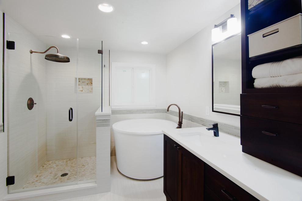 Inspiration for a medium sized modern ensuite bathroom in Seattle with shaker cabinets, dark wood cabinets, a japanese bath, a corner shower, a one-piece toilet, white tiles, porcelain tiles, white walls, porcelain flooring, a submerged sink, engineered stone worktops, white floors and a hinged door.