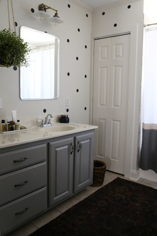 Inspiration for a small transitional master ceramic tile bathroom remodel in New Orleans with an integrated sink, raised-panel cabinets, gray cabinets and white walls