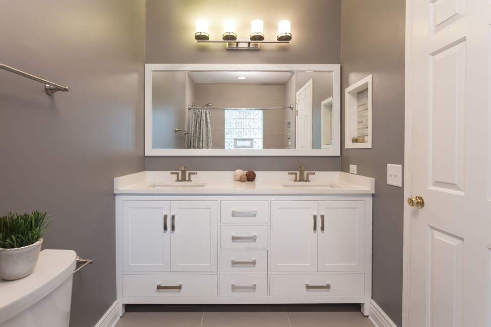 Inspiration for a medium sized modern ensuite bathroom in Chicago with white cabinets, an alcove bath, a shower/bath combination, a two-piece toilet, grey tiles, grey walls, ceramic flooring, beaded cabinets, a submerged sink and marble worktops.