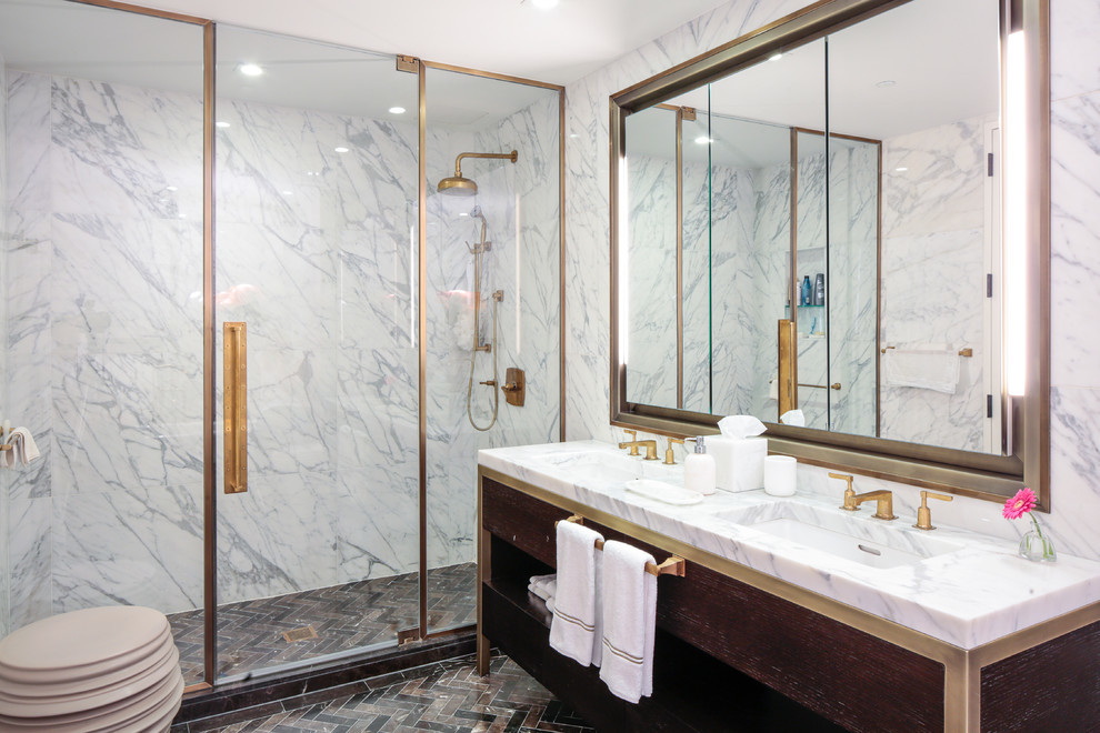 Example of a mid-sized trendy master white tile and marble tile ceramic tile and multicolored floor alcove shower design in New York with dark wood cabinets, white walls, an undermount sink, marble countertops, a hinged shower door, white countertops and flat-panel cabinets