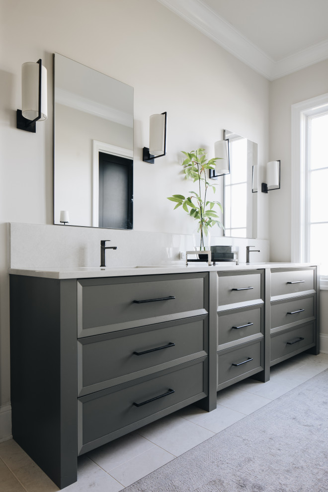 Classic ensuite bathroom in Chicago with recessed-panel cabinets, grey cabinets, beige walls, engineered stone worktops, white floors, white worktops, double sinks and a built in vanity unit.