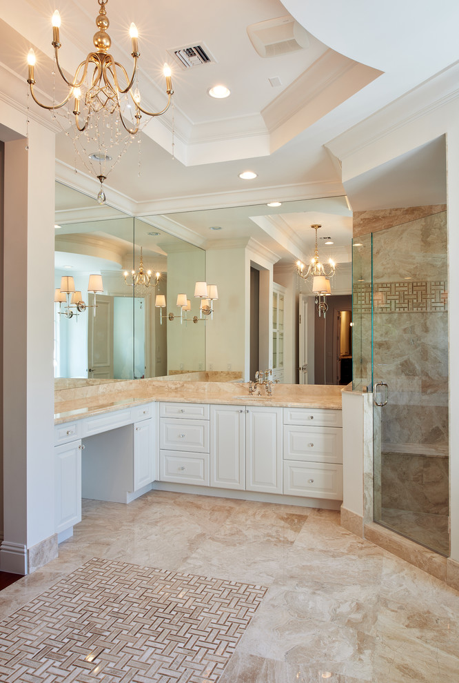 Example of a large transitional master beige tile marble floor bathroom design in Miami with an undermount sink, raised-panel cabinets, white cabinets, granite countertops and white walls