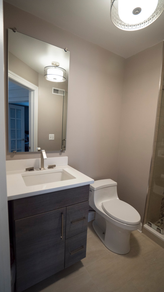 Photo of a small modern family bathroom in DC Metro with flat-panel cabinets, grey cabinets, a one-piece toilet, beige walls, porcelain flooring, a submerged sink, engineered stone worktops, beige floors, a hinged door, white worktops, a single sink, a built in vanity unit, beige tiles and porcelain tiles.