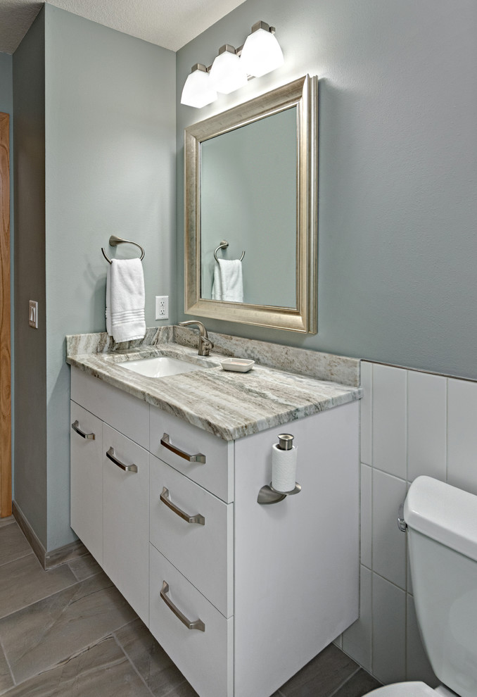 Walk-in shower - small contemporary green tile and porcelain tile porcelain tile and gray floor walk-in shower idea in Minneapolis with flat-panel cabinets, white cabinets, a two-piece toilet, green walls, an undermount sink, quartzite countertops and a hinged shower door