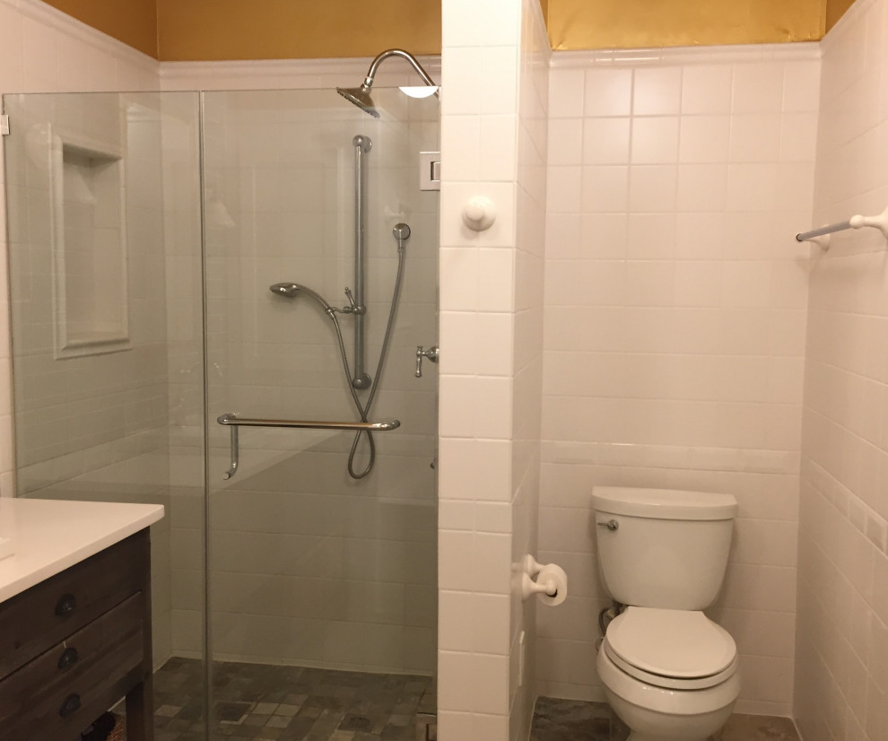 Inspiration for a medium sized urban ensuite bathroom in New York with freestanding cabinets, distressed cabinets, an alcove bath, an alcove shower, a two-piece toilet, white tiles, ceramic tiles, white walls, porcelain flooring, a built-in sink, engineered stone worktops, multi-coloured floors, a hinged door and white worktops.