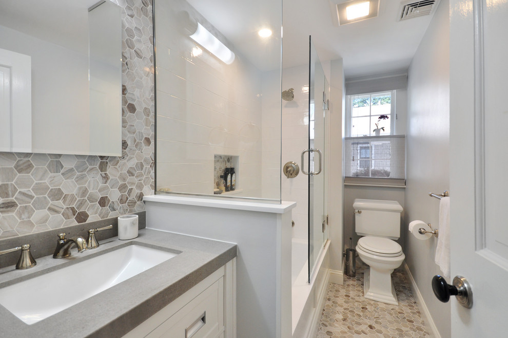 Bathroom - small traditional kids' white tile and subway tile marble floor and multicolored floor bathroom idea with shaker cabinets, white cabinets, a two-piece toilet, gray walls, an undermount sink, quartz countertops and a hinged shower door