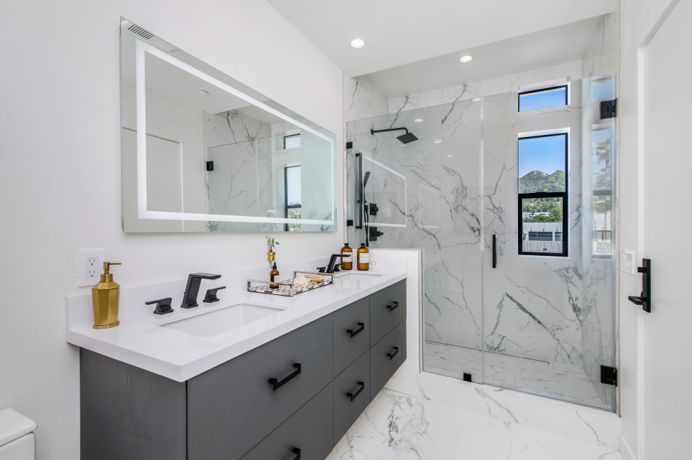 Inspiration for a contemporary 3/4 multicolored floor and double-sink alcove shower remodel in Los Angeles with flat-panel cabinets, gray cabinets, white walls, an undermount sink, white countertops and a floating vanity
