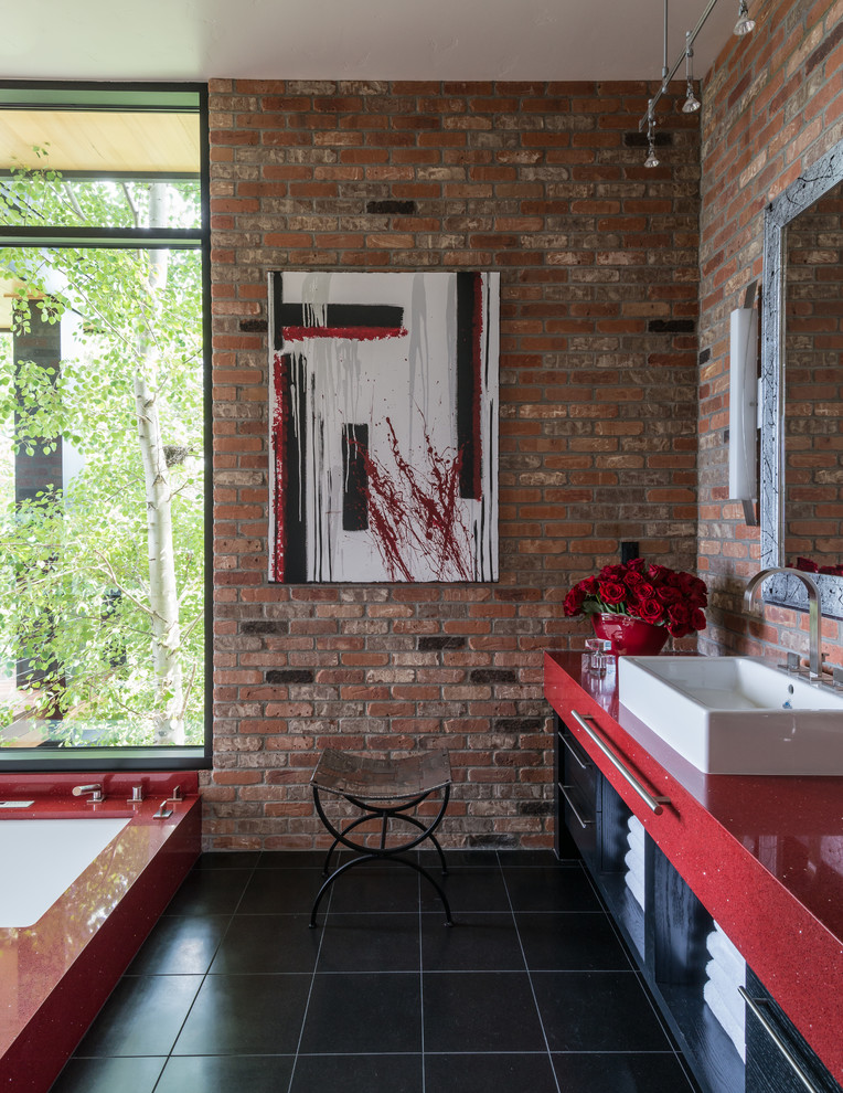 Inspiration for a contemporary master black tile and ceramic tile ceramic tile bathroom remodel in Other with a vessel sink, flat-panel cabinets, red cabinets, an undermount tub and red walls