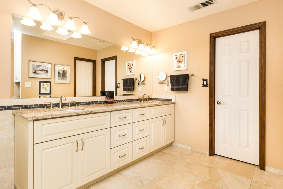 Inspiration for a large transitional master beige tile and glass tile ceramic tile and beige floor bathroom remodel in Albuquerque with raised-panel cabinets, white cabinets, beige walls, an undermount sink and quartz countertops