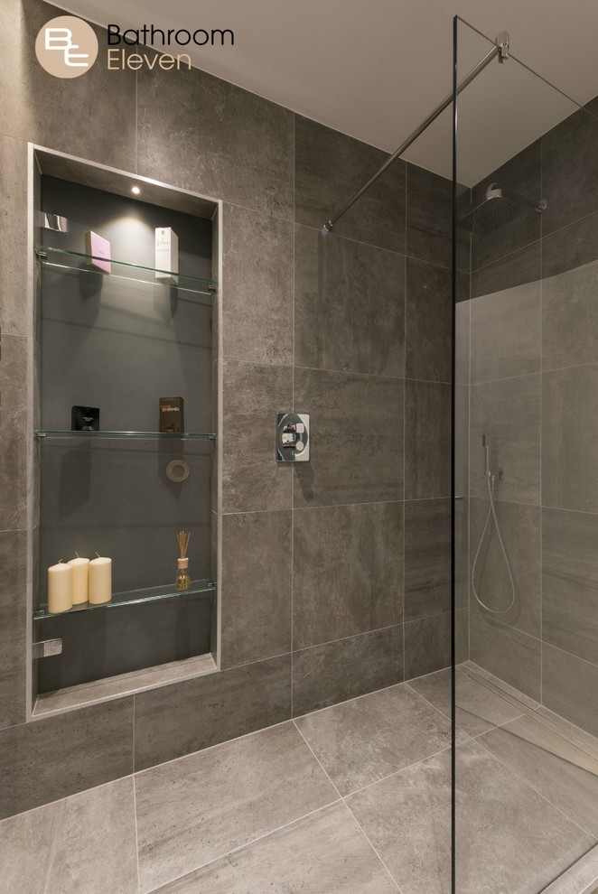 Inspiration for a contemporary bathroom with a walk-in shower, brown tiles, ceramic tiles, brown walls, ceramic flooring and a wall-mounted sink.