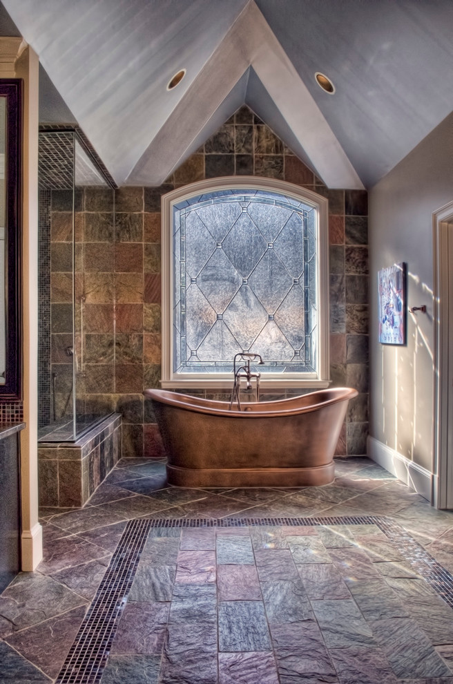 Example of a large classic master stone tile, brown tile, beige tile and gray tile slate floor bathroom design in Atlanta with a vessel sink, raised-panel cabinets, black cabinets, granite countertops and brown walls