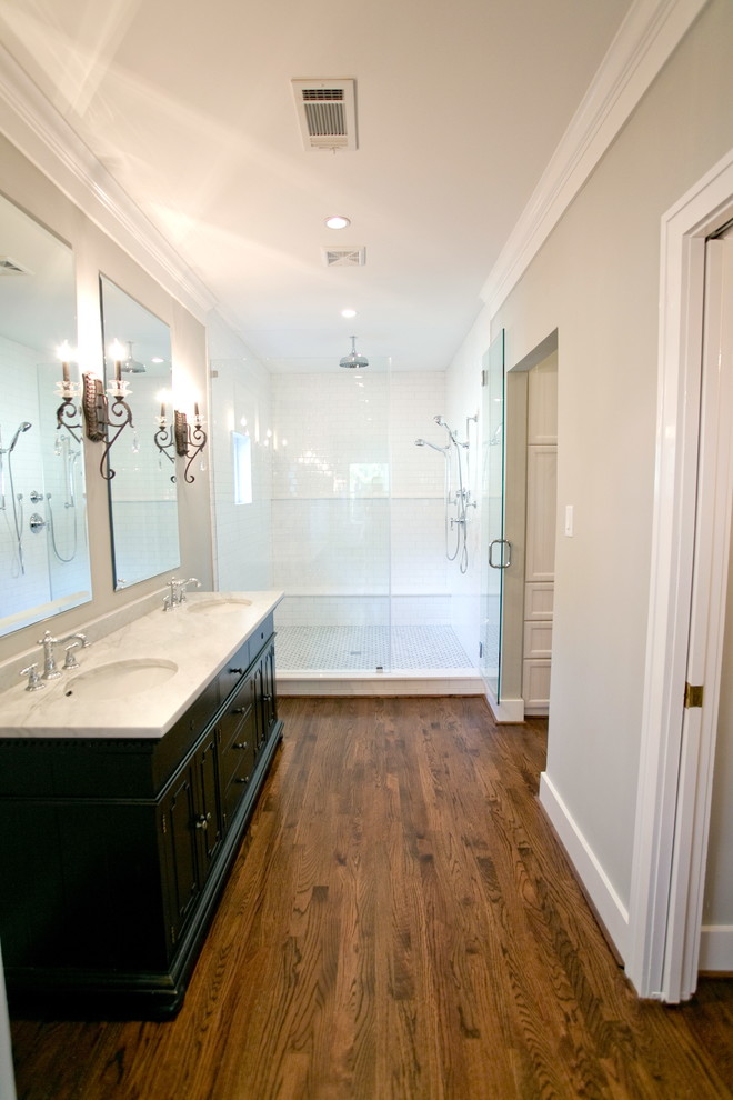 Mid-sized transitional master white tile and subway tile medium tone wood floor double shower photo in Houston with an undermount sink, furniture-like cabinets, black cabinets, marble countertops, a bidet and gray walls