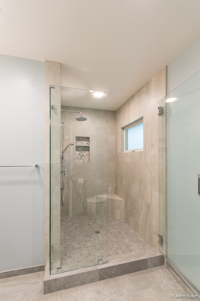 Medium sized contemporary ensuite bathroom in San Francisco with flat-panel cabinets, dark wood cabinets, a corner shower, a two-piece toilet, grey tiles, ceramic tiles, blue walls, porcelain flooring, a submerged sink, solid surface worktops, grey floors and a hinged door.