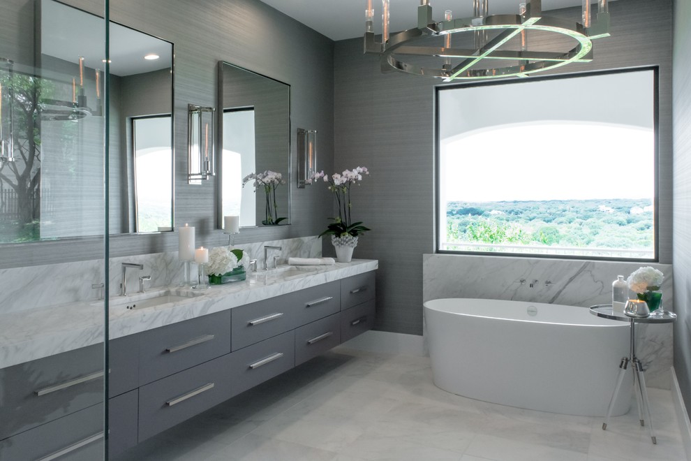 На фото: ванная комната в современном стиле с плоскими фасадами, серыми фасадами, отдельно стоящей ванной, серой плиткой, серыми стенами, врезной раковиной и серым полом