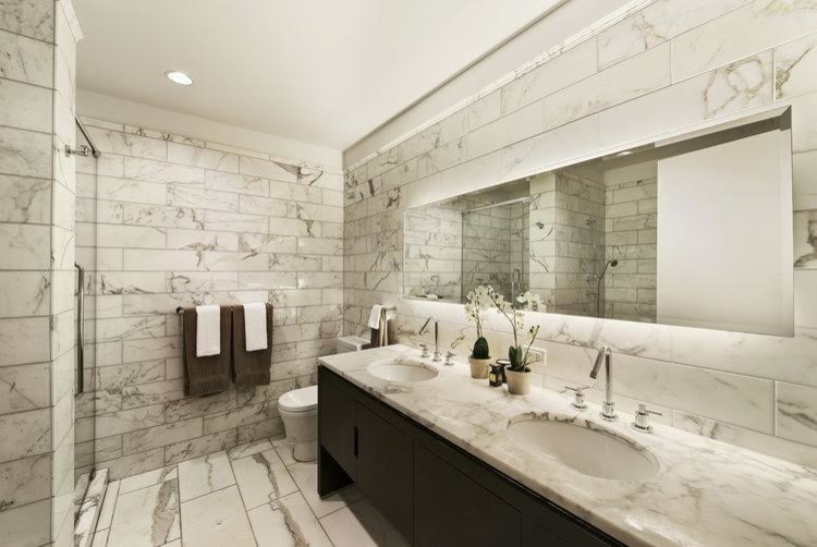 Small contemporary ensuite wet room bathroom with recessed-panel cabinets, black cabinets, a one-piece toilet, white tiles, marble tiles, white walls, marble flooring, a submerged sink, marble worktops, white floors and a hinged door.