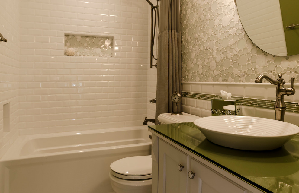 Bathroom - mid-sized transitional kids' white tile and ceramic tile ceramic tile bathroom idea in Chicago with a vessel sink, recessed-panel cabinets, white cabinets, glass countertops, a two-piece toilet and green walls