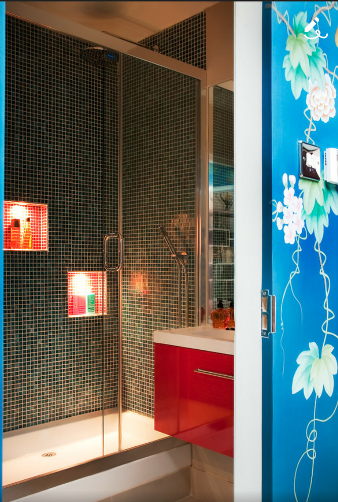 Small contemporary shower room bathroom in London with freestanding cabinets, red cabinets, a built-in shower, a wall mounted toilet, multi-coloured tiles, glass tiles, beige walls, porcelain flooring, a wall-mounted sink and marble worktops.