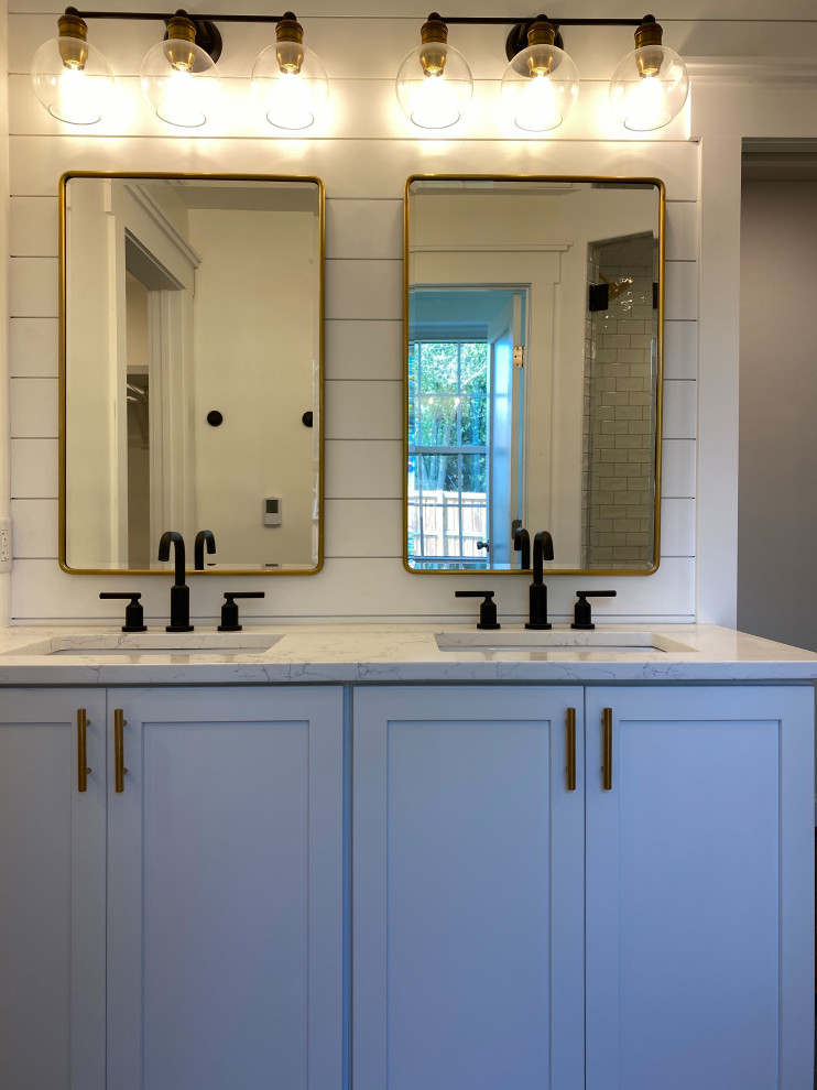 Inspiration for a medium sized classic ensuite bathroom in DC Metro with shaker cabinets, white cabinets, a corner shower, a one-piece toilet, white tiles, ceramic tiles, white walls, ceramic flooring, a submerged sink, quartz worktops, grey floors, a hinged door, white worktops, a shower bench, double sinks and a built in vanity unit.