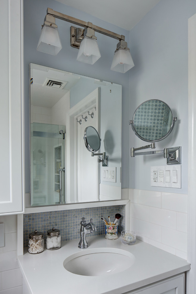 Small elegant master blue tile and mosaic tile marble floor bathroom photo in New York with recessed-panel cabinets, white cabinets, a two-piece toilet, blue walls, an undermount sink and quartz countertops