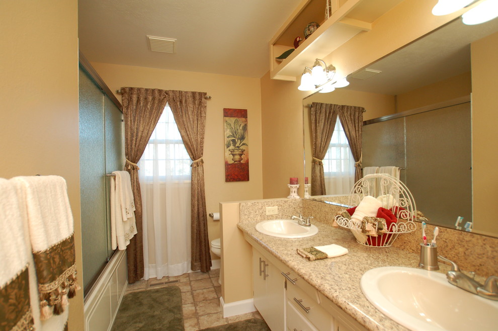 Example of a small classic 3/4 linoleum floor bathroom design in Boise with a drop-in sink, flat-panel cabinets, beige cabinets, laminate countertops, a two-piece toilet and beige walls