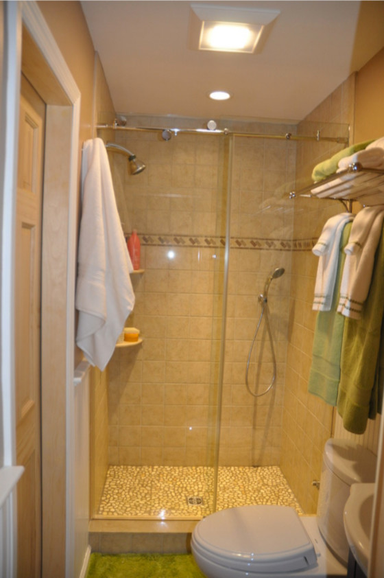 Example of a small classic 3/4 brown tile and ceramic tile brown floor bathroom design in New York with furniture-like cabinets, dark wood cabinets, brown walls and an integrated sink