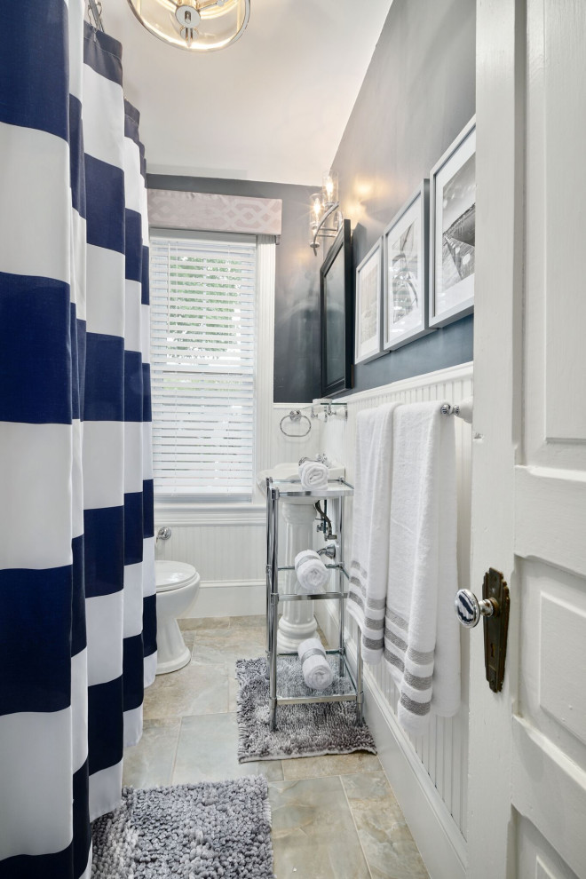 Small traditional shower room bathroom in Philadelphia with a claw-foot bath, a shower/bath combination, a one-piece toilet, white tiles, blue walls, ceramic flooring, a trough sink, beige floors and a shower curtain.