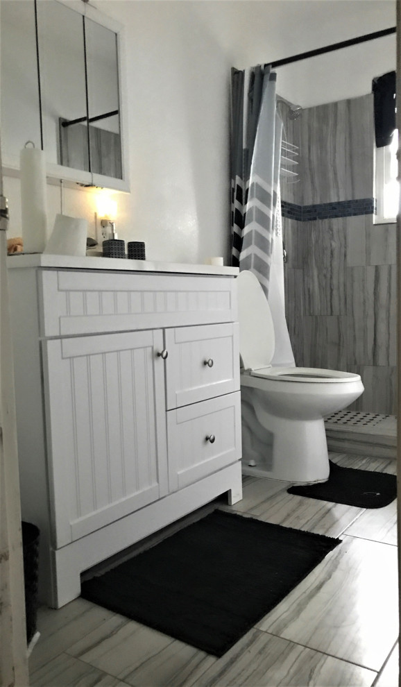 Inspiration pour une petite salle de bain minimaliste avec des portes de placard blanches, un carrelage gris, un mur blanc, un sol en carrelage de céramique et une cabine de douche avec un rideau.