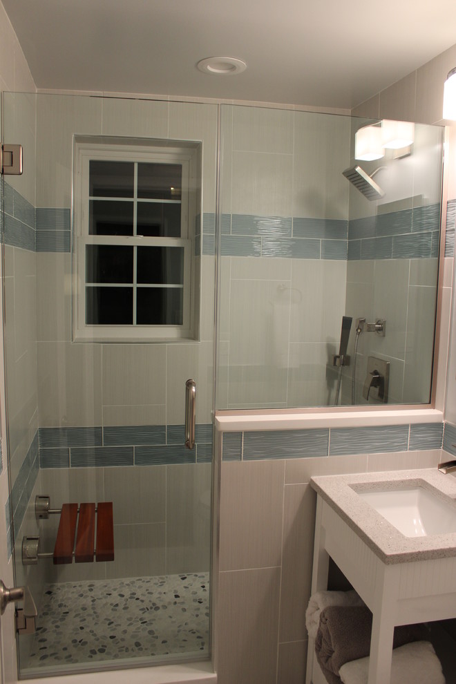 This is an example of a medium sized contemporary ensuite bathroom in DC Metro with a submerged sink, open cabinets, white cabinets, quartz worktops, an alcove shower, a two-piece toilet, multi-coloured tiles, white walls and limestone flooring.