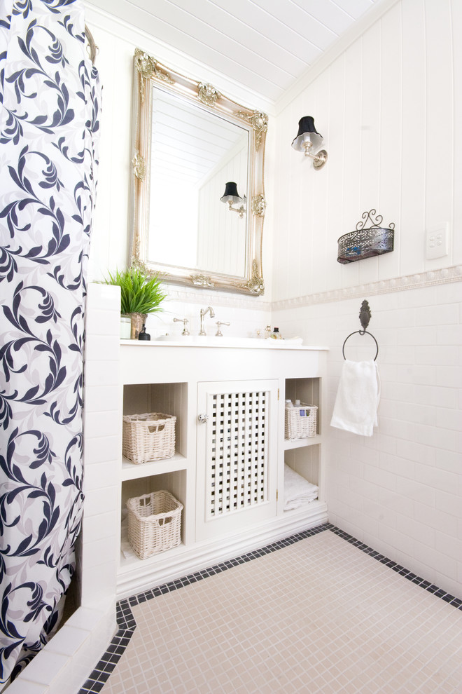 Corner shower - small traditional master black and white tile and porcelain tile mosaic tile floor corner shower idea in Brisbane with open cabinets, white cabinets, white walls and a drop-in sink