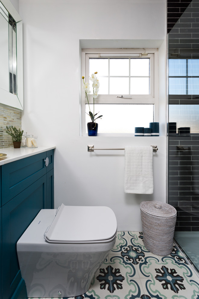 Источник вдохновения для домашнего уюта: маленькая ванная комната в современном стиле с фасадами с утопленной филенкой, синими фасадами, открытым душем, унитазом-моноблоком, черной плиткой, плиткой кабанчик, белыми стенами, полом из цементной плитки, душевой кабиной, накладной раковиной, столешницей из кварцита, разноцветным полом, открытым душем и белой столешницей для на участке и в саду