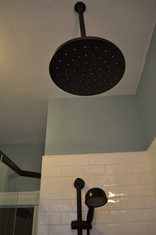 Elegant black tile and porcelain tile bathroom photo in Other with an undermount sink, shaker cabinets and white cabinets