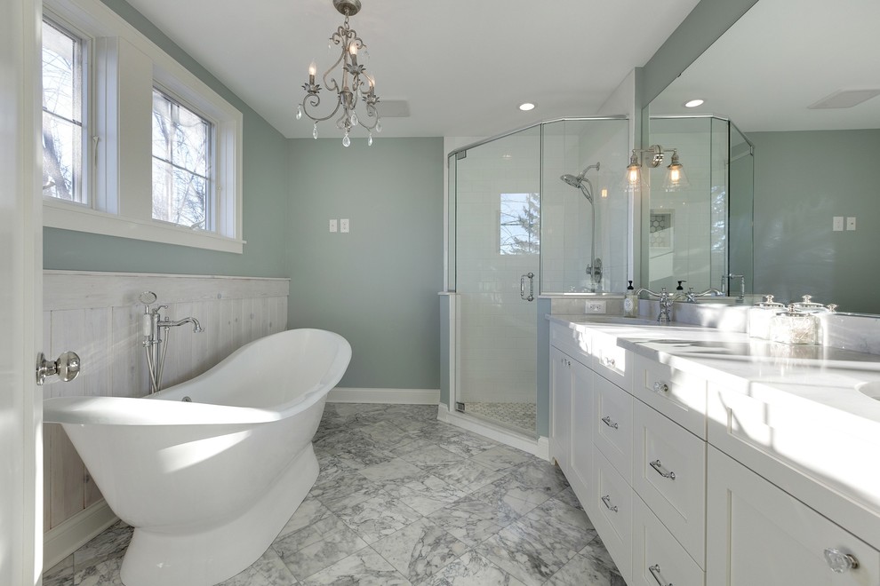 Example of a mid-sized transitional master white tile and porcelain tile marble floor bathroom design in Minneapolis with shaker cabinets, white cabinets, a one-piece toilet, green walls, an undermount sink and quartz countertops