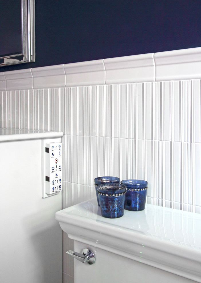 Medium sized traditional bathroom in New York with an integrated sink, white cabinets, an alcove bath, a shower/bath combination, white tiles, blue walls, mosaic tile flooring, freestanding cabinets, a one-piece toilet and ceramic tiles.