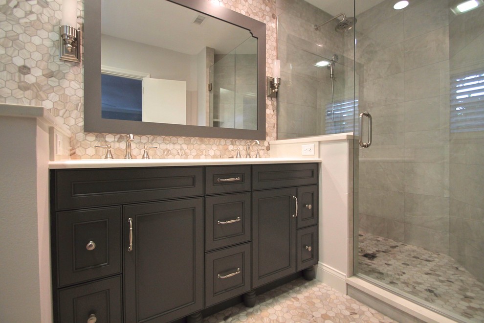 Corner shower - mid-sized transitional master gray tile and marble tile gray floor and marble floor corner shower idea in Orlando with recessed-panel cabinets, dark wood cabinets, gray walls, an undermount sink, quartzite countertops and a hinged shower door
