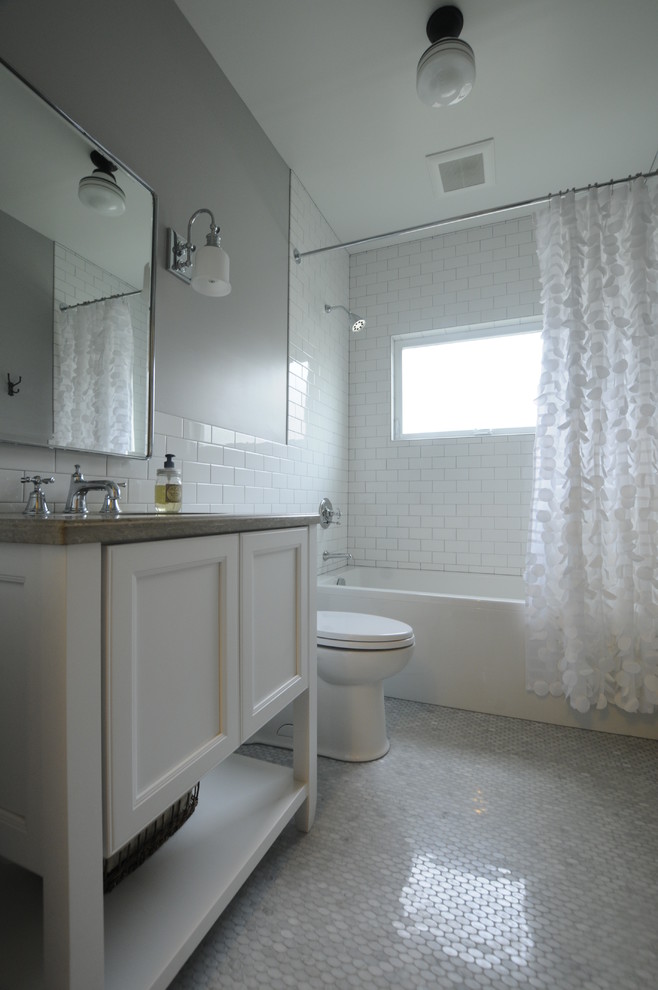 Example of a small transitional master white tile marble floor bathroom design in Seattle with white cabinets, a one-piece toilet, gray walls, an undermount sink and recessed-panel cabinets